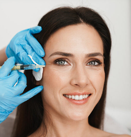 Photo of smiling woman getting mesotherapy treatment in face by specialist in gloves in beauty salon