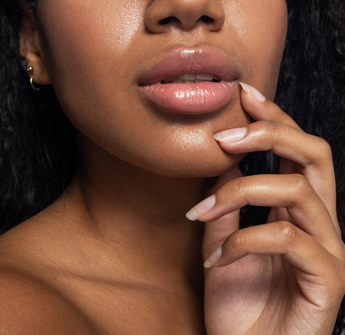 Sexy attractive woman posing for camera against light background. Perfect skin concept