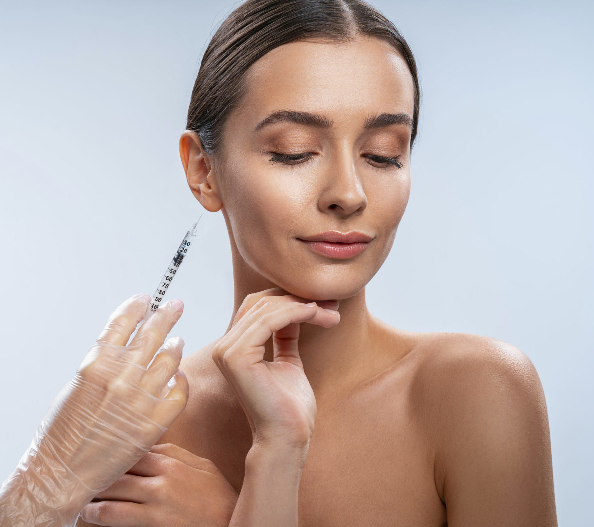 Prick of beauty. Beautiful girl standing isolated on white and preparing for beauty procedure